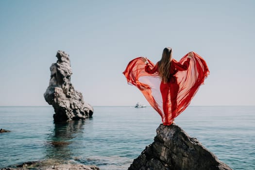 Woman travel sea. Happy tourist taking picture outdoors for memories. Woman traveler looks at the edge of the cliff on the sea bay of mountains, sharing travel adventure journey.