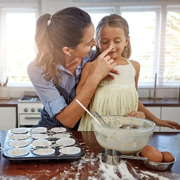 You need some flour power. a mother and her daughter baking in the kitchen