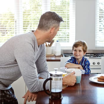 Breakfast bliss. a mid adult man and his son at home in the morning