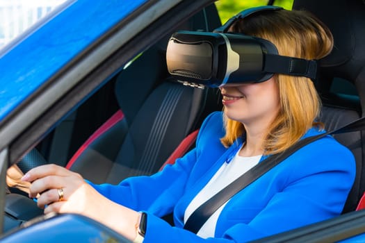 Business woman in the VR googles sitting in the car and turning the steering wheel in a car. Having fun and playing games with augmented reality