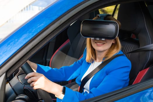 Smiling woman in the blue suit sitting in the car in VR goggles