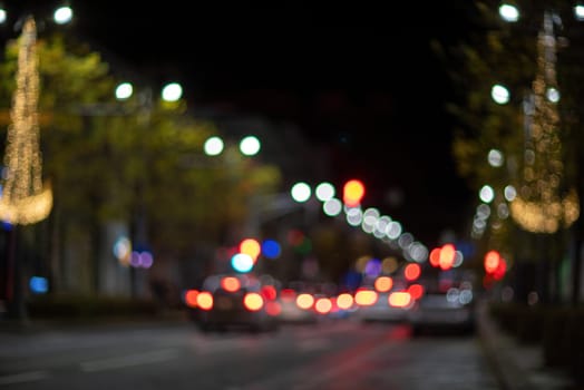 Blurred footage of transport. Blur of city lights along the road, light out of focus at night. Night city traffic, beautiful background