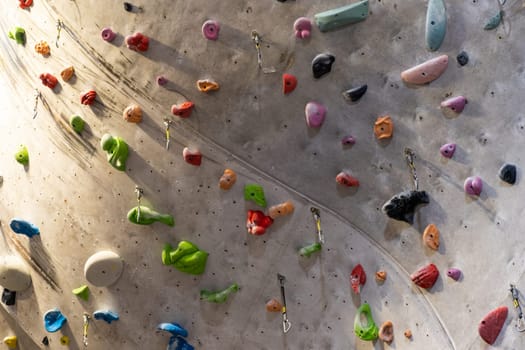 Artificial rock climbing wall with various colored grips.