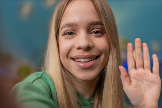 POV of Caucasian woman blogger taking selfie on smartphone, communicating video call online with social media subscribers followers, recording vlog stories. Young girl at home apartment room on couch