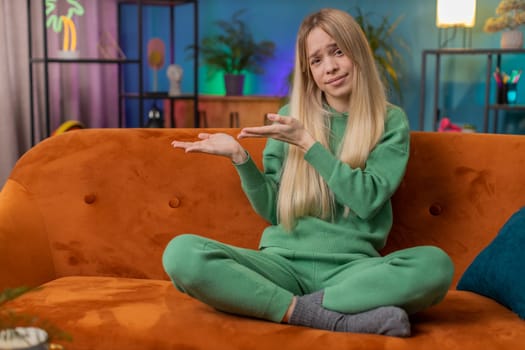 Young woman raising hands asking what why reason of failure, disbelief irritation by troubles, trendy social media meme, anti lifehacks, ridicules people who complicate simple tasks for no reason home