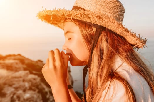 Portrait of young beautiful girl eating corn. Snacking on the sea