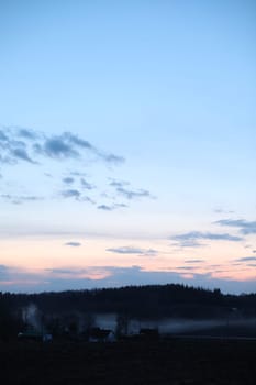 Glorious sunset over grassy rural landscape