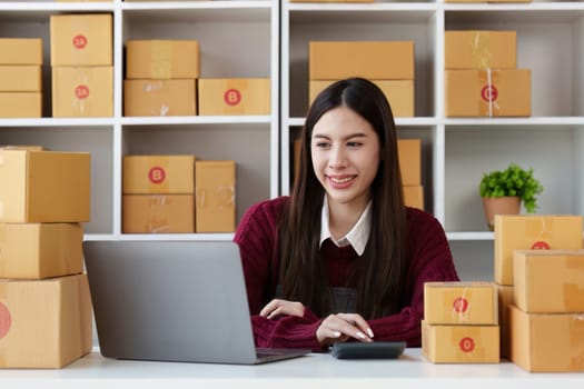 Small businesses SME owners female entrepreneurs check online orders to prepare to pack the boxes, sell to customers, sme business ideas online.