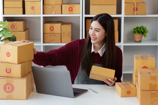 Small businesses SME owners female entrepreneurs check online orders to prepare to pack the boxes, sell to customers, sme business ideas online.