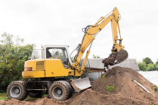 A excavator is digging on outdoors in an industrial site. Excavation works.