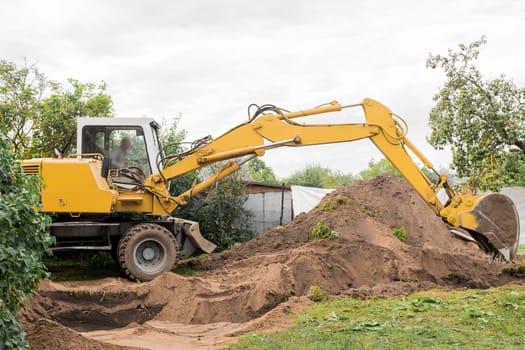 A excavator is digging on outdoors in an industrial site. Excavation works.