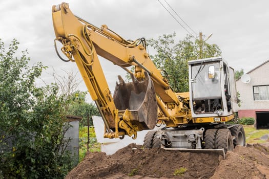 Bucket and hydraulic piston excavator or bulldozer close-up in industrial zone.