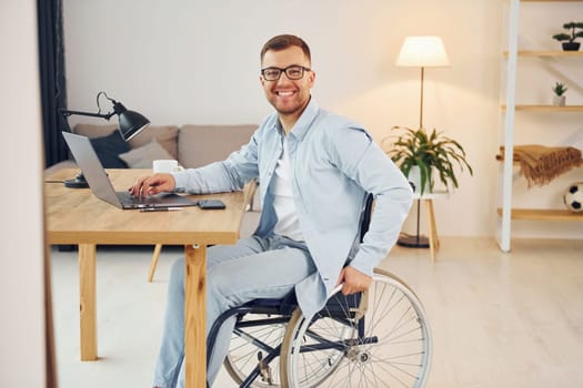 Working on a project from home. Disabled man in wheelchair.