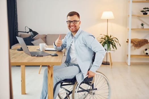 Working on a project from home. Disabled man in wheelchair.