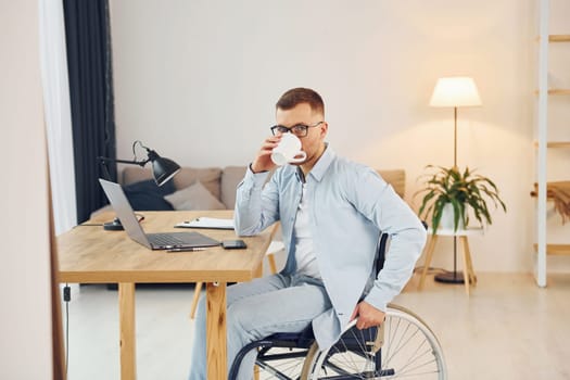 Working on a project from home. Disabled man in wheelchair.