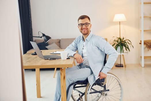 Working on a project from home. Disabled man in wheelchair.