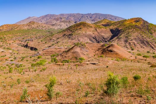 A picturesque mountain slope formed by volcanism overgrown with grass and bushes, Fogo Island, Cape Verde Islands