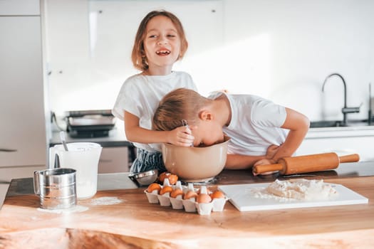 Preparing Christmas cookies. Little boy and girl on the kitchen.