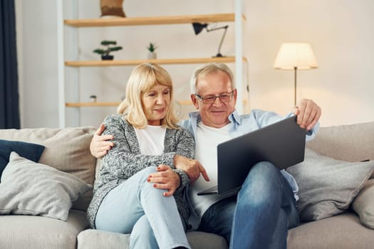 Internet connection. Using laptop. Senior man and woman is together at home.