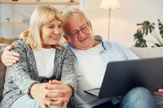 Internet connection. Using laptop. Senior man and woman is together at home.