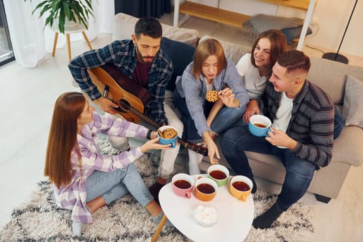 Weekend rest. Group of friends have party indoors together.