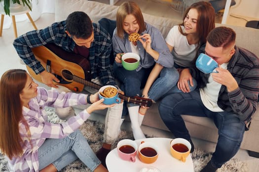 Weekend rest. Group of friends have party indoors together.