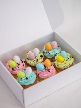 easter pastel handmade group of muffins with confetti chocolate eggs on top
