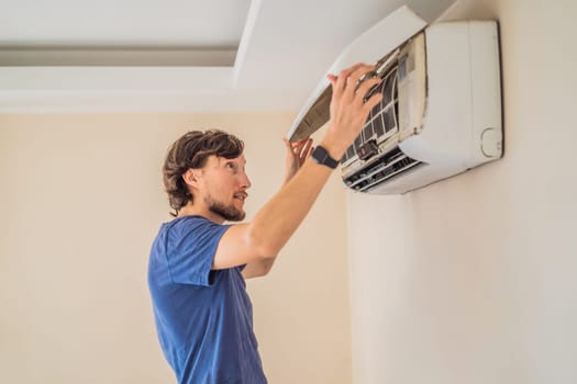 technician service removing air filter of the air conditioner for cleaning.