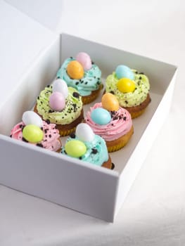 easter pastel handmade group of muffins with confetti chocolate eggs on top