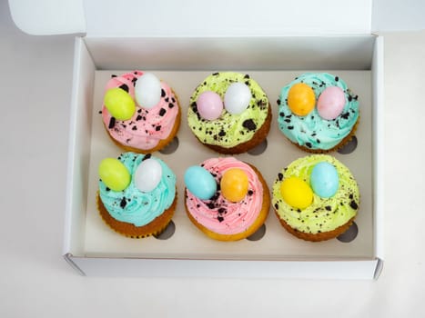 easter pastel handmade group of muffins with confetti chocolate eggs on top