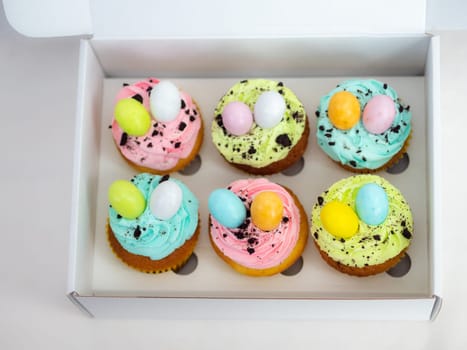 easter pastel handmade group of muffins with confetti chocolate eggs on top
