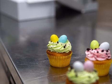 easter pastel handmade group of muffins with confetti chocolate eggs on top