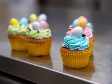 easter pastel handmade group of muffins with confetti chocolate eggs on top