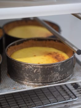 chef pastry baker cooking a bunch key lime pies in the oven