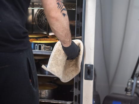 chef pastry baker cooking a bunch key lime pies in the oven