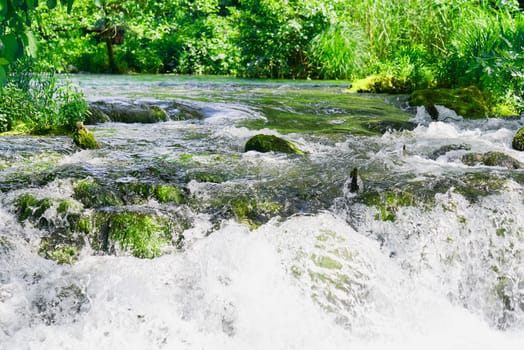 Beautiful Waterfall background in sunny summer day. Beautiful Waterfall In Krka National Park - Croatia, Europe. Krka river waterfalls in the Krka National Park