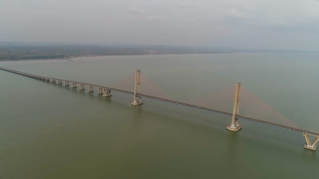 aerial view suspension cable bridge Suramadu over madura strait connecting islands Java and Madura. surabaya high coast bridge with highway. java, indonesia