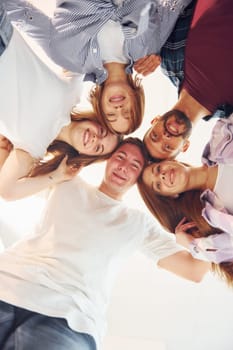 Looking down. Group of friends standing together.