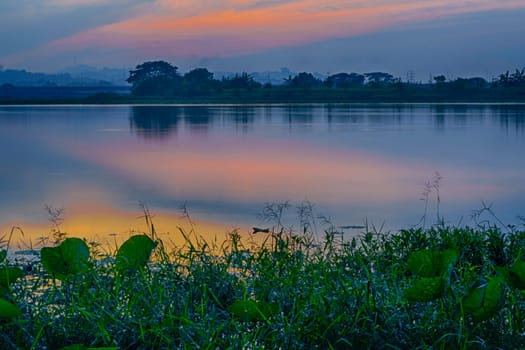 Beautiful view of Waduk Bunder or Water Dam Bunder in Gresik, East Java, Indonesia during sunrise and cloudy wheater.