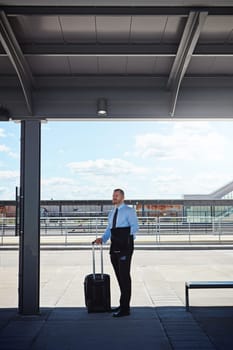 Not a rental car in sight. a professional businessman waiting for transportation outside an airport
