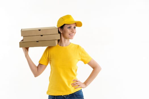 Woman in yellow shade and yellow cap holds boxes, pizza delivery girl on white background