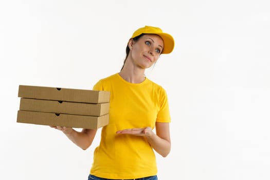 Woman in yellow shade and yellow cap holds boxes, pizza delivery girl on white background