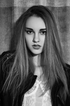 Beautiful fashion portrait of woman model in rock leather jacket with dark fashionable make-up. Modern street fashion look.Long hairstyle with straight smooth hair