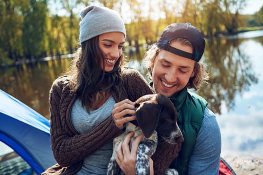 We brought our best friend along with us. a loving couple on a camping trip