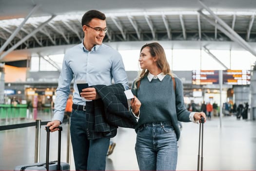 Walking indoors. Young couple is in the airport together.