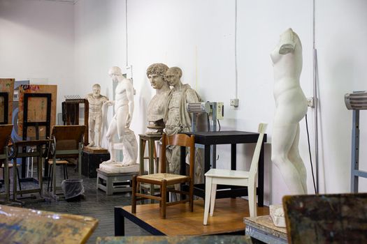 Easels, statues and chairs in the painting classroom of fine art school