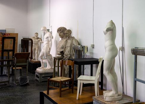 Easels, statues and chairs in the painting classroom of fine art school