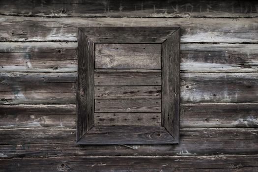 Wooden boarded up window. The structure is dark in color, creating a bad mood and melancholy. Parallel lines run horizontally across the entire wall.