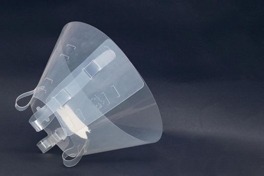 Plastic protective collar for an animal close up on gray background, copy space
