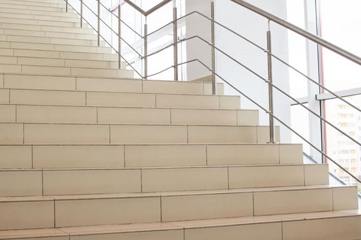 Steps stairs in the hall of the building by windows